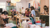 people browsing brightly lit Rouge shop for home goods and vintage Chinese furniture 