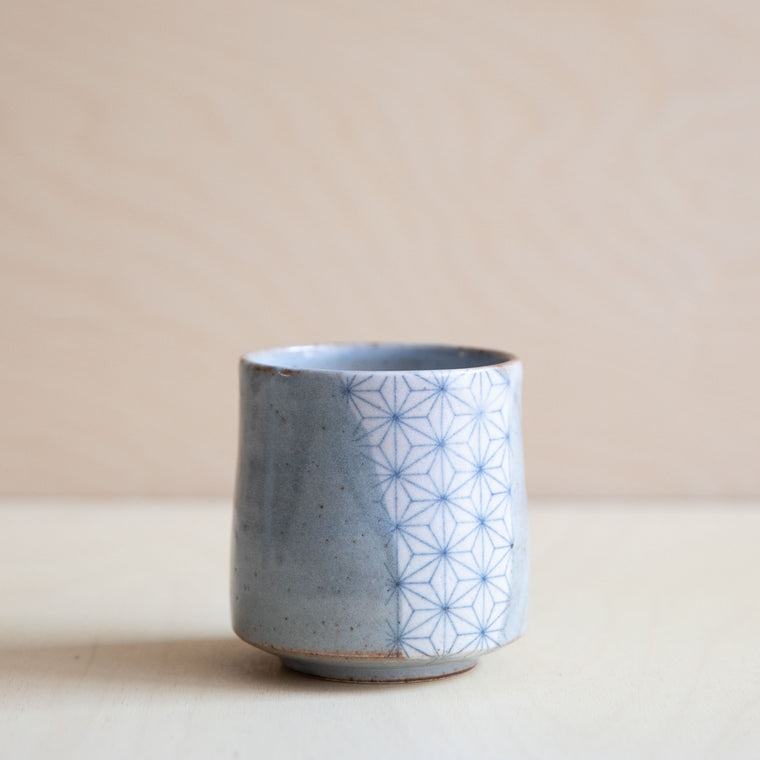 grey glazed cup with a patch of asanoha design