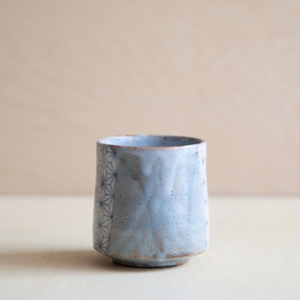 grey glazed cup with a patch of asanoha design different angle