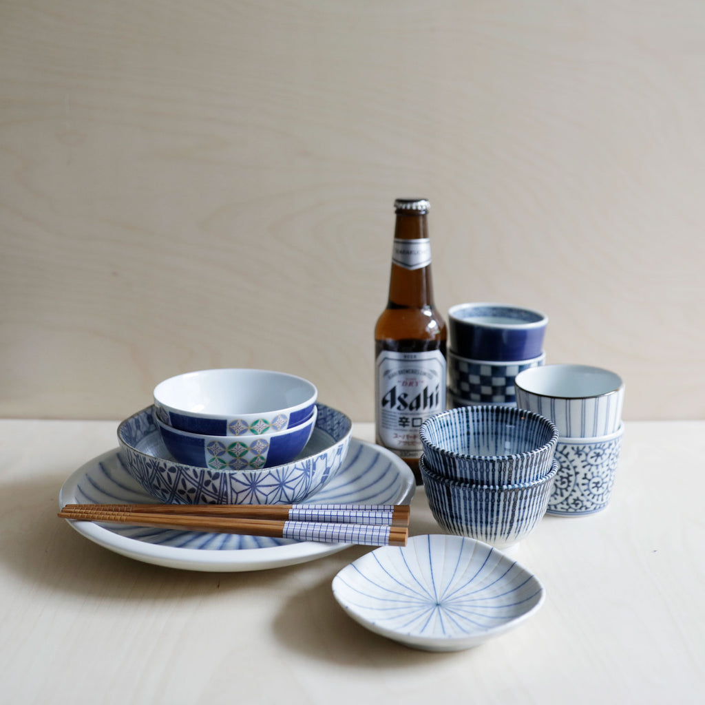 Blue soba cups with ceramic bowls and beer